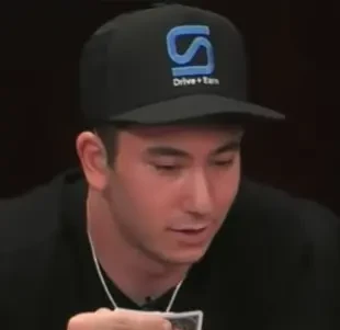 Adam Cohen seated playing mid-stakes cash game poker on the Hustler Casino Live stream.