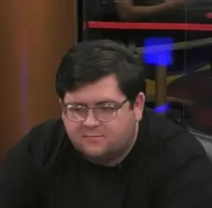 Drew B seated playing mid-stakes cash game poker on the Hustler Casino Live stream.