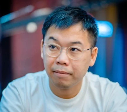 Elton Tsang seated playing high stakes cash game poker on Triton Poker.