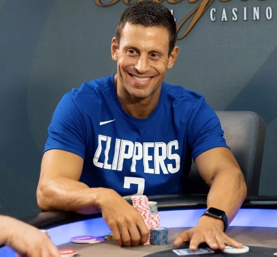 Garrett Adelstein seated playing high stakes cash game poker at Hustler Casino Live.
