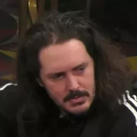 Justin seated playing high stakes cash game poker on the Hustler Casino Live stream.