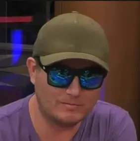 Michael Scott seated playing mid stakes cash game poker on the Hustler Casino Live stream.