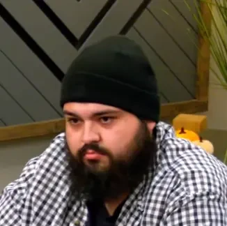 Nicholas seated playing low stakes cash game poker on the Hustler Casino Live stream.
