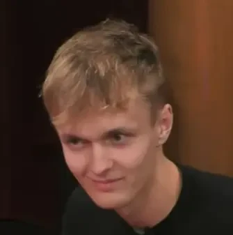 Nikolai seated playing mid-stakes cash game poker on the Hustler Casino Live stream.