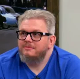 Phil seated playing low stakes cash game poker on the Poker At The Lodge livestrea.