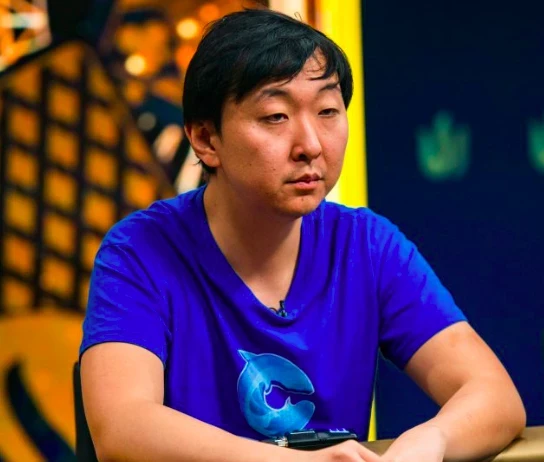 Rui Cao seated playing high stakes cash game poker on Triton Poker.