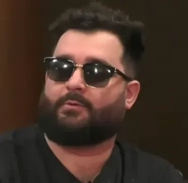 Sergei seated playing high stakes cash game poker on the Hustler Casino Live stream.