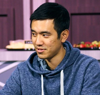 Stanley Tang seated playing poker on PokerGO's High Stakes Poker cash game show.